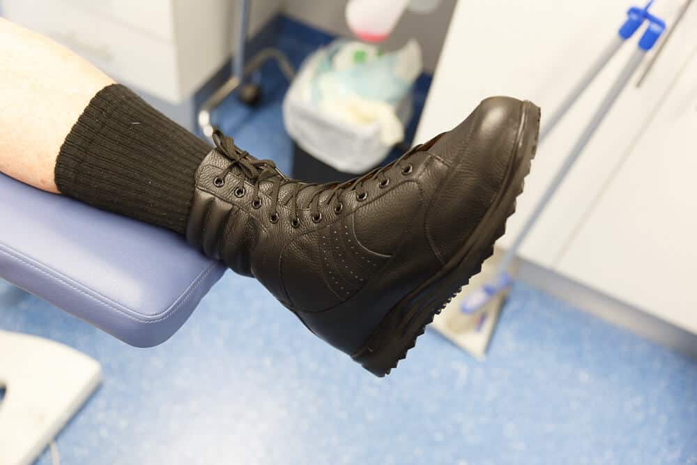 A Person wearing a Custom Footwear Black boots